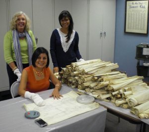Nancy Atkins Peck, Xiomara Paredes and Faulizbeth Vallejo cleaning and examining the plans of architect Carl Kemm Loven at the headquarters of the Glen Rock Historical Society (left to right).