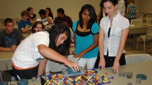 Students (from left) Melissa Garcia of Vineland High School, Nadia Albino of Bridgeton High School and Rosa Melillo of Vineland High School work on a model bridge.